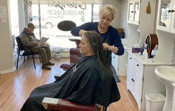 Woman Getting Hair Cut at George's Barber Shop Prince George